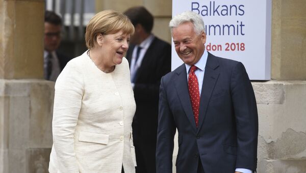 Britain's Minister of State for Europe and the Americas Alan Duncan, right, greets German Chancellor Angela Merkel outside Lancaster House in London, during the second day of the Western Balkans summit, Tuesday July 10, 2018. - Sputnik International