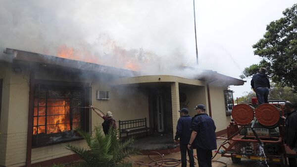 Firemen attempt to extinguish s fire at a white residence in Coligny, South Africa, in the town where two South Africa white farmers were released on bail by the magistrates court, Monday May 8, 2017. The two, who are accused of murdering a black teenager, were granted bail in the racially sensitive case that sparked racial violence. - Sputnik International