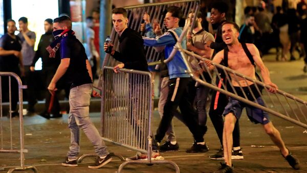 Soccer Football - World Cup - Semi-Final - France vs Belgium - Paris, France, July 11, 2018 - France fans with barriers clash on the Champs-Elysees after their World Cup semi-final match - Sputnik International