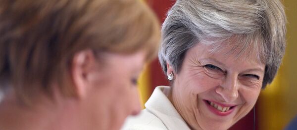 Britain's Prime Minister Theresa May, and Germany's Chancellor Angela Merkel hold a news conference with Polish Prime Minister, Mateusz Morawiecki (unseen) during the Western Balkans Summit 2018 at Lancaster House in London, Britain, July 10, 2018 Britain's Prime Minister Theresa May, and Germany's Chancellor Angela Merkel hold a news conference with Polish Prime Minister, Mateusz Morawiecki (unseen) during the Western Balkans Summit 2018 at Lancaster House in London, Britain, July 10, 2018 - Sputnik International