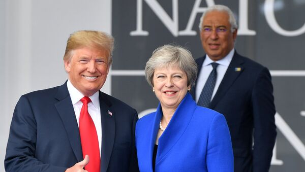 US President Donald Trump (L) gestures as he poses alongside Britain's Prime Minister Theresa May (R) as Portugal's Prime Minister Antonio Costa (TOP) looks on during the opening ceremony of the NATO (North Atlantic Treaty Organization) summit, at the NATO headquarters in Brussels, on July 11, 2018. - Sputnik International