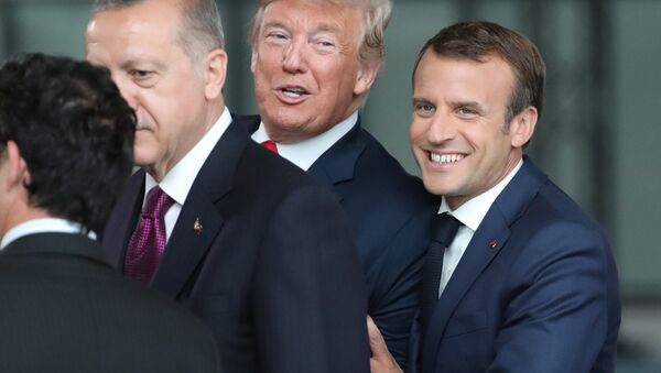 France's President Emmanuel Macron (R) jokes with US President Donald Trump (C) next to Turkey’s President Recep Tayyip Erdogan as they arrive for the NATO (North Atlantic Treaty Organization) summit, at the NATO headquarters in Brussels, on July 11, 2018. - Sputnik International