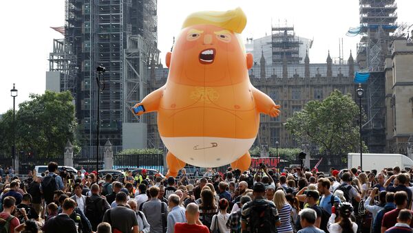 Demonstrators fly a blimp portraying U.S. President Donald Trump, in Parliament Square, during the visit by Trump and First Lady Melania Trump in London, Britain July 13, 2018 - Sputnik International