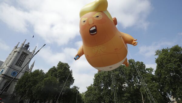 A six-meter high cartoon baby blimp of U.S. President Donald Trump is flown as a protest against his visit, in Parliament Square in London, England, Friday, July 13, 2018 - Sputnik International