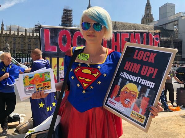 A woman holding signs mocking the US president at an anti-Trump rally in London, UK - Sputnik International