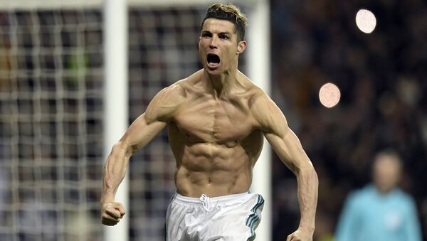 (FILES) In this file photo taken on April 11, 2018 Real Madrid's Portuguese forward Cristiano Ronaldo celebrates after scoring a penalty during the UEFA Champions League quarter-final second leg football match between Real Madrid CF and Juventus FC at the Santiago Bernabeu stadium in Madrid on April 11, 2018 - Sputnik International