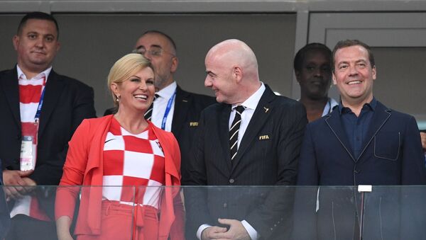 Russian Prime Minister Dmitry Medvedev and President of the Republic of Croatia Kolinda Grabar-Kitarović are on the stand during the 2018 FIFA World Cup quarterfinal match between the national teams of Russia and Croatia. Center: FIFA president Gianni Infantino - Sputnik International