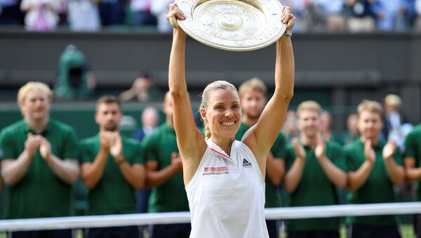 Tennis - Wimbledon - All England Lawn Tennis and Croquet Club, London, Britain - July 14, 2018 Germany's Angelique Kerber holds the trophy after winning the women's singles final against Serena Williams of the U.S. - Sputnik International