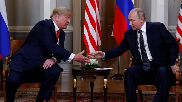 U.S. President Donald Trump and Russia's President Vladimir Putin shake hands as they meet in Helsinki, Finland July 16, 2018 - Sputnik International
