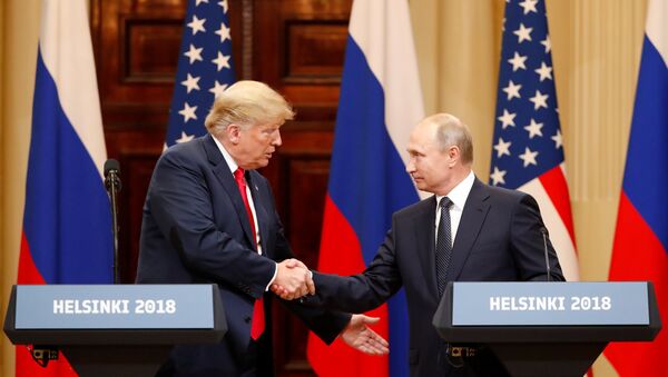 U.S. President Donald Trump and Russian President Vladimir Putin shake hands as they hold a joint news conference after their meeting in Helsinki, Finland July 16, 2018 - Sputnik International