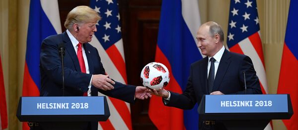 Russia's President Vladimir Putin (R) offers a ball of the 2018 football World Cup to US President Donald Trump during a joint press conference after a meeting at the Presidential Palace in Helsinki, on July 16, 2018 Russia's President Vladimir Putin (R) offers a ball of the 2018 football World Cup to US President Donald Trump during a joint press conference after a meeting at the Presidential Palace in Helsinki, on July 16, 2018 - Sputnik International