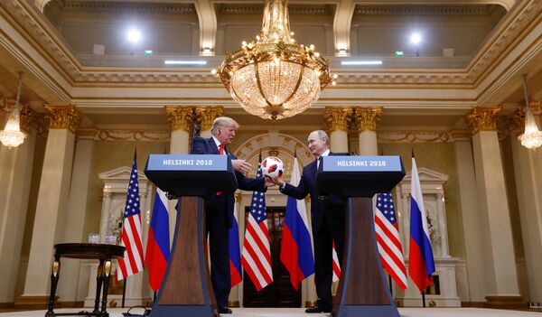 U.S. President Donald Trump receives a football from Russia's President Vladimir Putin during their joint news conference after a meeting in Helsinki, Finland, July 16, 2018 U.S. President Donald Trump receives a football from Russia's President Vladimir Putin during their joint news conference after a meeting in Helsinki, Finland, July 16, 2018 - Sputnik International