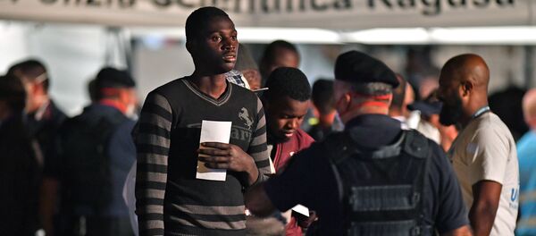 A migrant is pictured after disembarking from the Italian Coast Guard vessel Diciotti at the port of Pozzallo, Sicily on June 19, 2018, following a rescue operation of migrants and refugees at sea A migrant is pictured after disembarking from the Italian Coast Guard vessel Diciotti at the port of Pozzallo, Sicily on June 19, 2018, following a rescue operation of migrants and refugees at sea - Sputnik International