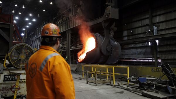 In this Thursday, June 28, 2018, file photo senior melt operator Randy Feltmeyer watches a giant ladle as it backs away after pouring its contents of red-hot iron into a vessel in the basic oxygen furnace as part of the process of producing steel at the U.S. Steel Granite City Works facility in Granite City, Ill. - Sputnik International