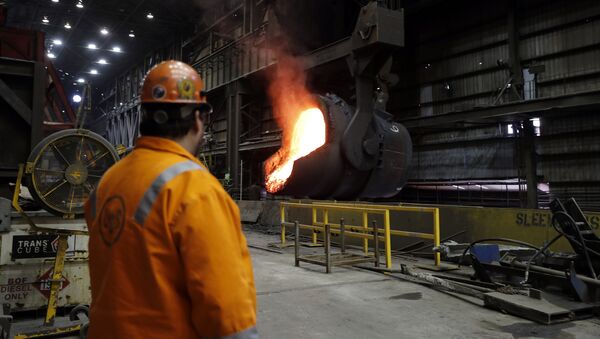 In this Thursday, June 28, 2018, file photo senior melt operator Randy Feltmeyer watches a giant ladle as it backs away after pouring its contents of red-hot iron into a vessel in the basic oxygen furnace as part of the process of producing steel at the U.S. Steel Granite City Works facility in Granite City, Ill. - Sputnik International
