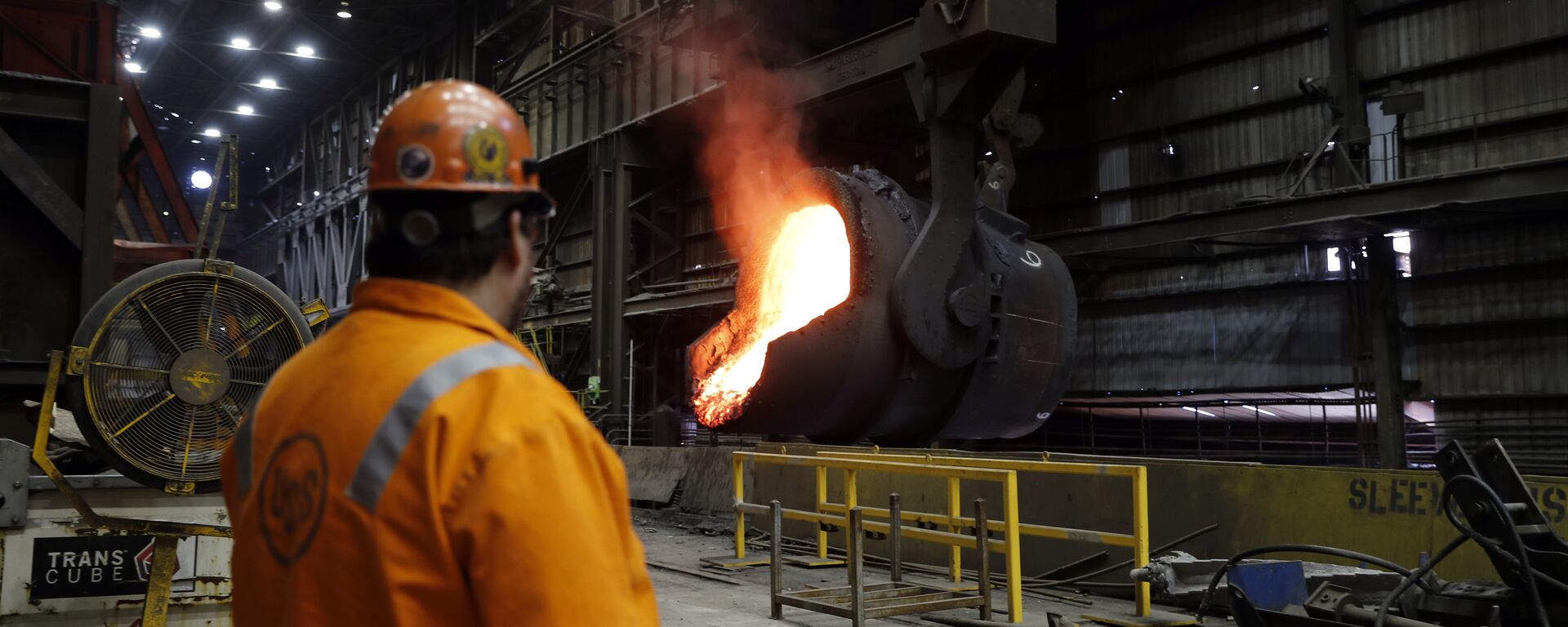 In this Thursday, June 28, 2018, file photo senior melt operator Randy Feltmeyer watches a giant ladle as it backs away after pouring its contents of red-hot iron into a vessel in the basic oxygen furnace as part of the process of producing steel at the U.S. Steel Granite City Works facility in Granite City, Ill. - Sputnik International, 1920, 25.02.2025