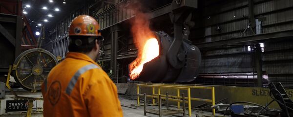 In this Thursday, June 28, 2018, file photo senior melt operator Randy Feltmeyer watches a giant ladle as it backs away after pouring its contents of red-hot iron into a vessel in the basic oxygen furnace as part of the process of producing steel at the U.S. Steel Granite City Works facility in Granite City, Ill. - Sputnik International