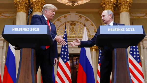 U.S. President Donald Trump and Russia's President Vladimir Putin shake hands during a joint news conference after their meeting in Helsinki, Finland, July 16, 2018 - Sputnik International