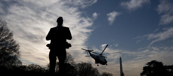 A Secret Service agent stands guard as Marine One with President Donald Trump aboard departs the White House in Washington, Saturday, Dec. 2, 2017, for a short trip to Andrews Air Force Base, Md. where Trump will travel to New York for a fundraising event - Sputnik International