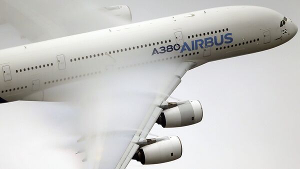 In this June 18 2015 file photo, vapour forms across the wings of an Airbus A380 as it performs a demonstration flight at the Paris Air Show, Le Bourget airport, north of Paris - Sputnik International