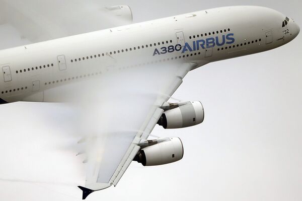 In this June 18 2015 file photo, vapour forms across the wings of an Airbus A380 as it performs a demonstration flight at the Paris Air Show, Le Bourget airport, north of Paris - Sputnik International