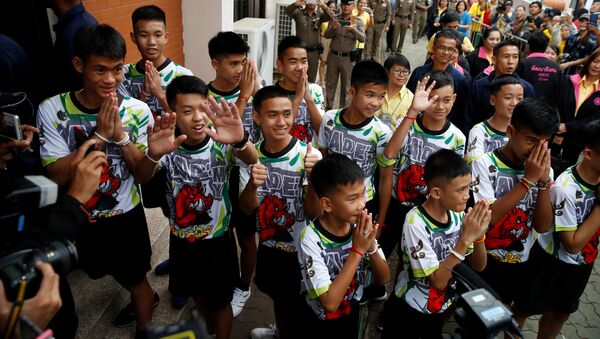 The 12 boys and their soccer coach who were rescued from a flooded cave arrive for a news conference in the northern province of Chiang Rai, Thailand, July 18, 2018 - Sputnik International