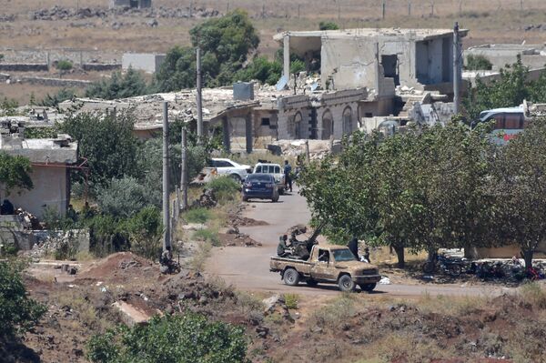 An armed man rides a pickup truck at the Syrian side of the Israeli-Syrian border as it is seen from the Israeli-occupied Golan Heights, Israel July 20, 2018 An armed man rides a pickup truck at the Syrian side of the Israeli-Syrian border as it is seen from the Israeli-occupied Golan Heights, Israel July 20, 2018 - Sputnik International