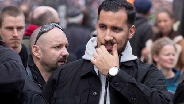 Alexandre Benalla, French presidential aide, is seen during the May Day labour union rally in Paris, France May 1, 2018. At L, Vincent Crase, employee of LREM - Sputnik International