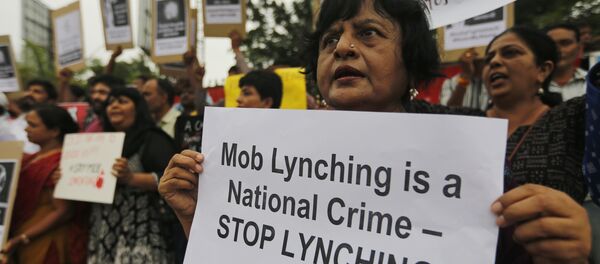 Indians hold placards and shout slogans during a protest against mob attacks in Ahmadabad, India, Monday, July 23, 2018 Indians hold placards and shout slogans during a protest against mob attacks in Ahmadabad, India, Monday, July 23, 2018 - Sputnik International