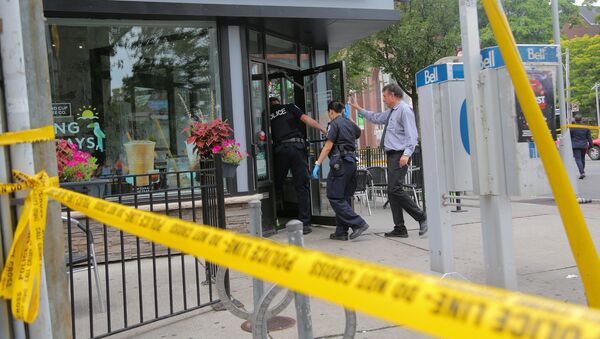 Police officers enter a coffee shop damaged by gunfire while investigating a mass shooting on Danforth Avenue in Toronto, Canada, July 23, 2018 - Sputnik International
