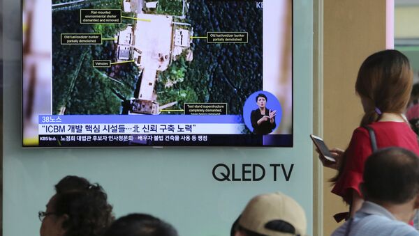A TV screen shows a satellite image of North Korea's Sohae launch site, during a news program at the Seoul Railway Station in Seoul, South Korea, Tuesday, July 24, 2018. - Sputnik International