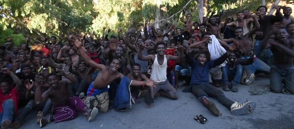African migrants react in this still image from video after crossing the border from Morocco to Spain's North African enclave of Ceuta, Spain, July 26, 2018 African migrants react in this still image from video after crossing the border from Morocco to Spain's North African enclave of Ceuta, Spain, July 26, 2018 - Sputnik International