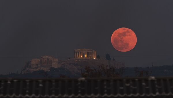 A boat sails in the Bosporus Strait separating Europe and Asia, as a super blue blood moon rises over Istanbul, Wednesday, Jan. 31, 2018. It's the first time in 35 years a blue moon has synced up with a supermoon and a total lunar eclipse, or blood moon because of its red hue, all rolled into one celestial phenomenon - Sputnik International