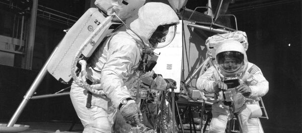 Two members of the Apollo 11 lunar landing mission participate in a simulation of deploying and using lunar tools on the surface of the Moon during a training exercise on April 22, 1969 - Sputnik International