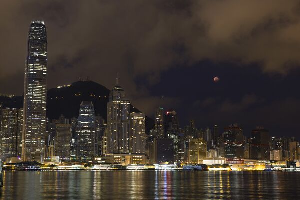 A full moon rises over the Victoria Harbour during a complete lunar eclipse, in Hong Kong, Saturday, July 28, 2018. Skywatchers around much of the world are looking forward to a complete lunar eclipse that will be the longest this century. A full moon rises over the Victoria Harbour during a complete lunar eclipse, in Hong Kong, Saturday, July 28, 2018. Skywatchers around much of the world are looking forward to a complete lunar eclipse that will be the longest this century. - Sputnik International