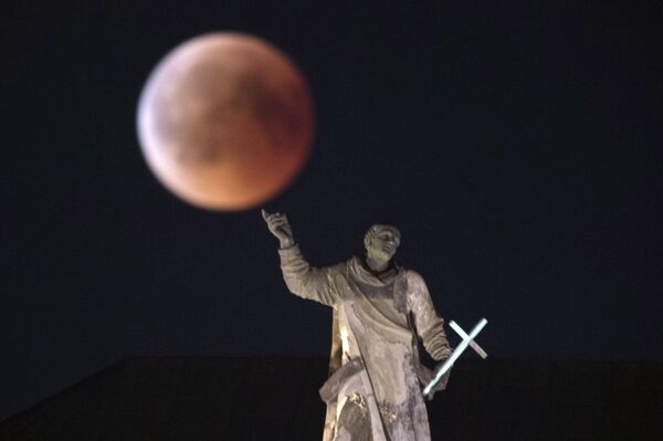 The moon turns red during a total lunar eclipse, as seen from Dresden, Germany, Friday, July 27, 2018. Skywatchers around much of the world are looking forward to a complete lunar eclipse that will be the longest this century. The moon turns red during a total lunar eclipse, as seen from Dresden, Germany, Friday, July 27, 2018. Skywatchers around much of the world are looking forward to a complete lunar eclipse that will be the longest this century. - Sputnik International