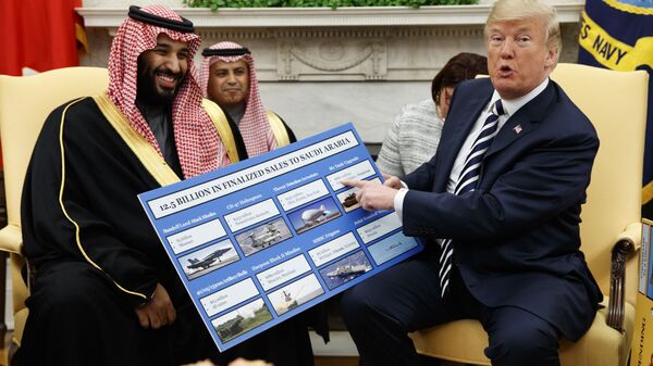 US President Donald Trump shows a chart highlighting arms sales to Saudi Arabia during a meeting with Saudi Crown Prince Mohammed bin Salman in the Oval Office of the White House, Tuesday, March 20, 2018, in Washington - Sputnik International