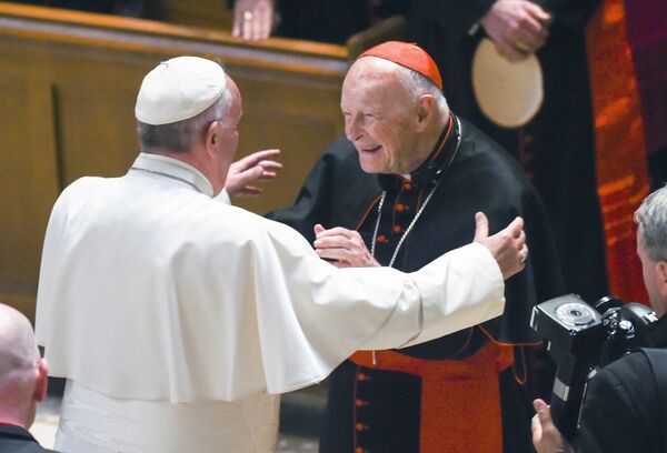In this Sept. 23, 2015 file photo, Pope Francis reaches out to hug Cardinal Archbishop emeritus Theodore McCarrick after the Midday Prayer of the Divine with more than 300 U.S. Bishops at the Cathedral of St. Matthew the Apostle in Washington. Pope Francis has accepted U.S. prelate Theodore McCarrick's offer to resign from the College of Cardinals following allegations of sexual abuse, including one involving an 11-year-old boy, and ordered him to conduct a life of prayer and penance in a home to be designated by the pontiff until a church trial is held, the Vatican said Saturday - Sputnik International
