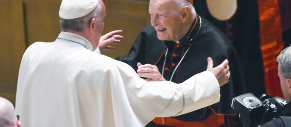 In this Sept. 23, 2015 file photo, Pope Francis reaches out to hug Cardinal Archbishop emeritus Theodore McCarrick after the Midday Prayer of the Divine with more than 300 U.S. Bishops at the Cathedral of St. Matthew the Apostle in Washington. Pope Francis has accepted U.S. prelate Theodore McCarrick's offer to resign from the College of Cardinals following allegations of sexual abuse, including one involving an 11-year-old boy, and ordered him to conduct a life of prayer and penance in a home to be designated by the pontiff until a church trial is held, the Vatican said Saturday In this Sept. 23, 2015 file photo, Pope Francis reaches out to hug Cardinal Archbishop emeritus Theodore McCarrick after the Midday Prayer of the Divine with more than 300 U.S. Bishops at the Cathedral of St. Matthew the Apostle in Washington. Pope Francis has accepted U.S. prelate Theodore McCarrick's offer to resign from the College of Cardinals following allegations of sexual abuse, including one involving an 11-year-old boy, and ordered him to conduct a life of prayer and penance in a home to be designated by the pontiff until a church trial is held, the Vatican said Saturday - Sputnik International
