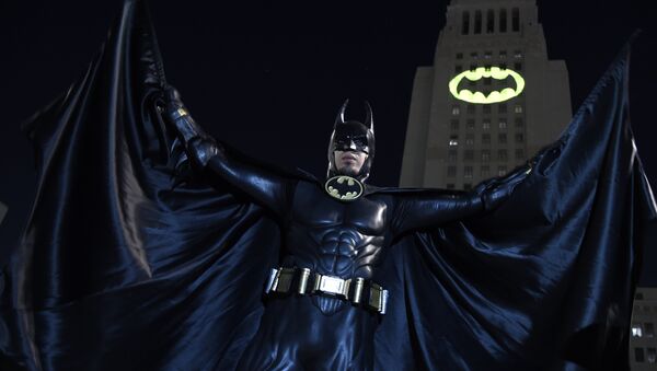 Caeser Saend, of Los Angeles, poses in front of a Bat-Signal projected onto City Hall at a tribute to Batman star Adam West on Thursday, June 15, 2017, in Los Angeles - Sputnik International