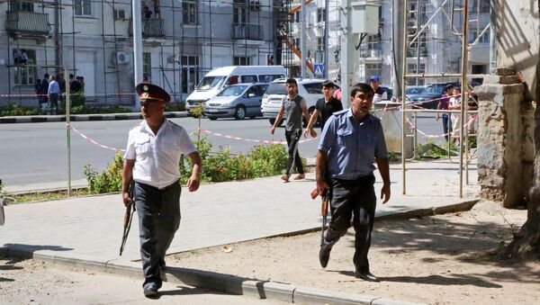Police officers secure an area in the capital of Tajikistan, Dushanbe, where several Interior Ministry special forces officers and a traffic policeman were reportedly shot dead earlier on Friday, Sept. 4, 2015. - Sputnik International