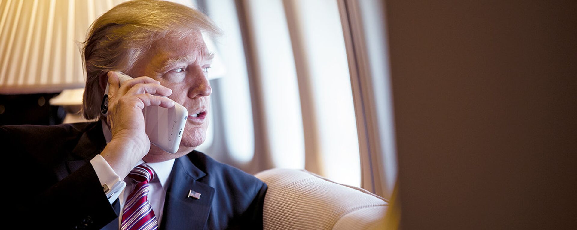 President Donald Trump talks on the phone aboard Air Force One during a flight to Philadelphia, Pennsylvania, to address a joint gathering of House and Senate Republicans, Thursday, January 26, 2017 (File photo). - Sputnik International, 1920, 04.12.2020