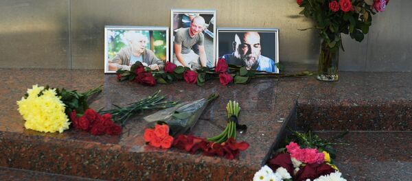 Flowers brought at the photos of three Russian journalists killed in the Central African Republic, from right: Orkhan Dzhemal, Kirill Radchenko and Alexander Rastorguyev, near the Central House of Journalists in Moscow. File photo Flowers brought at the photos of three Russian journalists killed in the Central African Republic, from right: Orkhan Dzhemal, Kirill Radchenko and Alexander Rastorguyev, near the Central House of Journalists in Moscow. File photo - Sputnik International