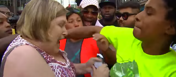 Minnesota woman gets punched for ripping up a demonstrator's protest sign during a rally protesting the fatal shooting of Thurman Blevins Minnesota woman gets punched for ripping up a demonstrator's protest sign during a rally protesting the fatal shooting of Thurman Blevins - Sputnik International
