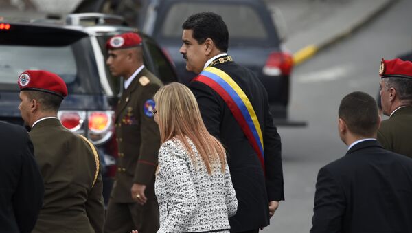 Venezuelan President Nicolas Maduro (C) and his wife Cilia Flores arrive for a ceremony to celebrate the 81st anniversary of the National Guard in Caracas on August 4, 2018 day in which Venezuela's controversial Constituent Assembly marks its first anniversary. The Constituent Assembly marks its first anniversary on August 4 as the embodiment of Maduro's entrenchment in power despite an economic crisis that has crippled the country's public services and destroyed its currency. The assembly's very creation last year was largely responsible for four months of street protests that left some 125 people dead. - Sputnik International