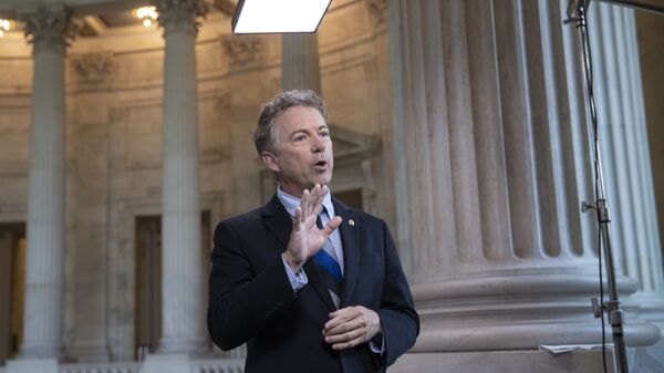 During a TV news interview, Sen. Rand Paul, R-Ky., defends President Donald Trump and his Helsinki news conference with Russian President Vladimir Putin whereTrump appeared to cast doubt on U.S. intelligence findings that Russia interfered in the 2016 election, on Capitol Hill in Washington, Tuesday, July 17, 2018 - Sputnik International