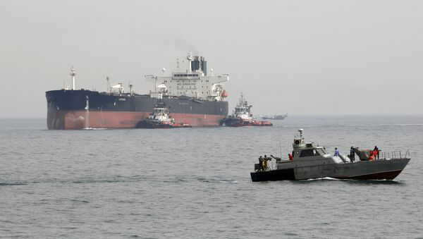 A picture taken on March 12, 2017, shows an Iranian military speedboat patrols the waters as a tanker perpares to dock at the oil facility in the Khark Island, on the shore of the Gulf - Sputnik International