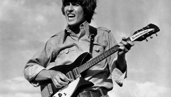 Beatle George Harrison is shown playing the guitar in a scene from the Beatles movie Help! on location in the Bahamas in 1965. - Sputnik International