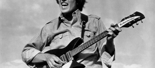 Beatle George Harrison is shown playing the guitar in a scene from the Beatles movie Help! on location in the Bahamas in 1965. - Sputnik International