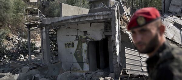 A Palestinian Hamas military policeman inspects the damage caused by Israeli airstrikes in Gaza City, Thursday, Aug. 9, 2018. Israel struck targets in the Gaza Strip after dozens of rockets were launched Wednesday from the coastal territory ruled by the Islamic militant Hamas group, the Israeli military said A Palestinian Hamas military policeman inspects the damage caused by Israeli airstrikes in Gaza City, Thursday, Aug. 9, 2018. Israel struck targets in the Gaza Strip after dozens of rockets were launched Wednesday from the coastal territory ruled by the Islamic militant Hamas group, the Israeli military said - Sputnik International
